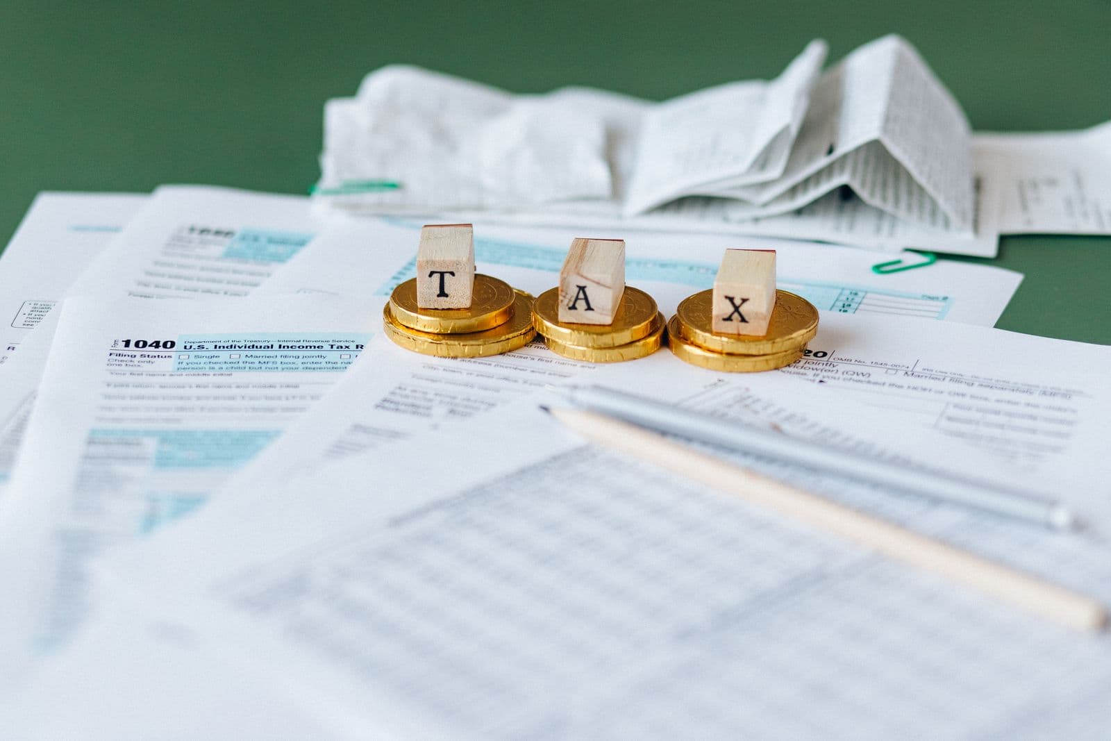 Tax forms and a printed receipt spread across a desk